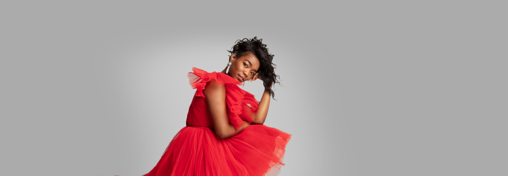 A young woman in a festive red holiday dress